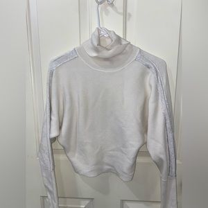 Jennifer Lopez white turtleneck with shimmery arm stripe